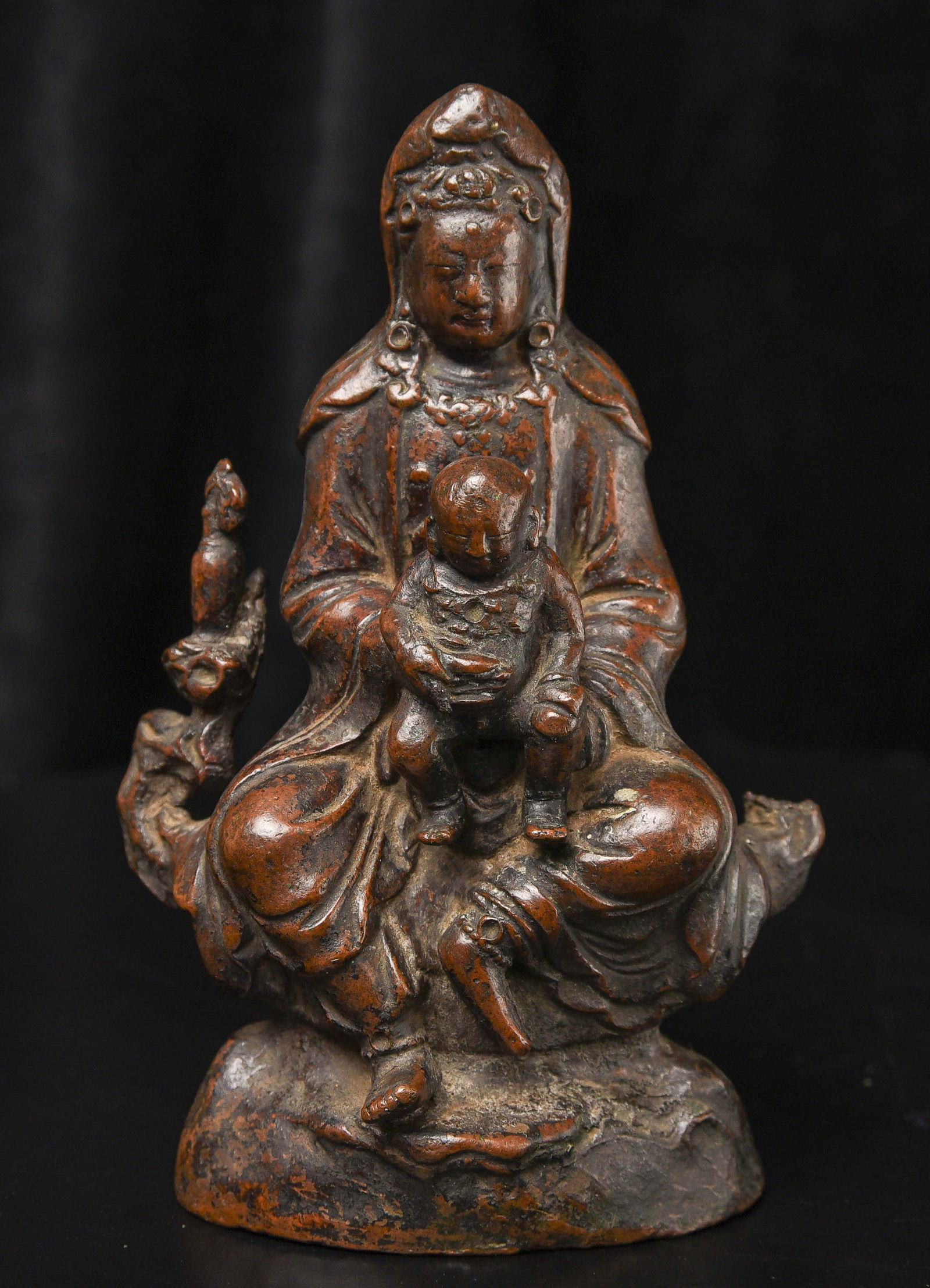 Fine Ming/Ching Quanyin with baby. Great finesse to the: 18thC Bronze Quanyin with Baby Buddha. Beautifully sculpted, cast, and finished. The face is exceptional. The way patina has developed makes it even more beautiful. ( 4.75"H x 3"W x 2.75"D ) - 2.29lbs