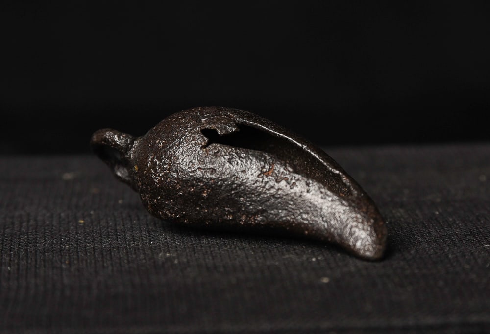 Early Thai (Sukhothai?) bell. Still rattles and could be worn.: Early Thai (Sukhothai?) bell. Still rattles and could be worn. Probably over 500 years old. Reportedly found in the jungle near the ancient ruins of Sukhothai in the first part of the 20th century. On