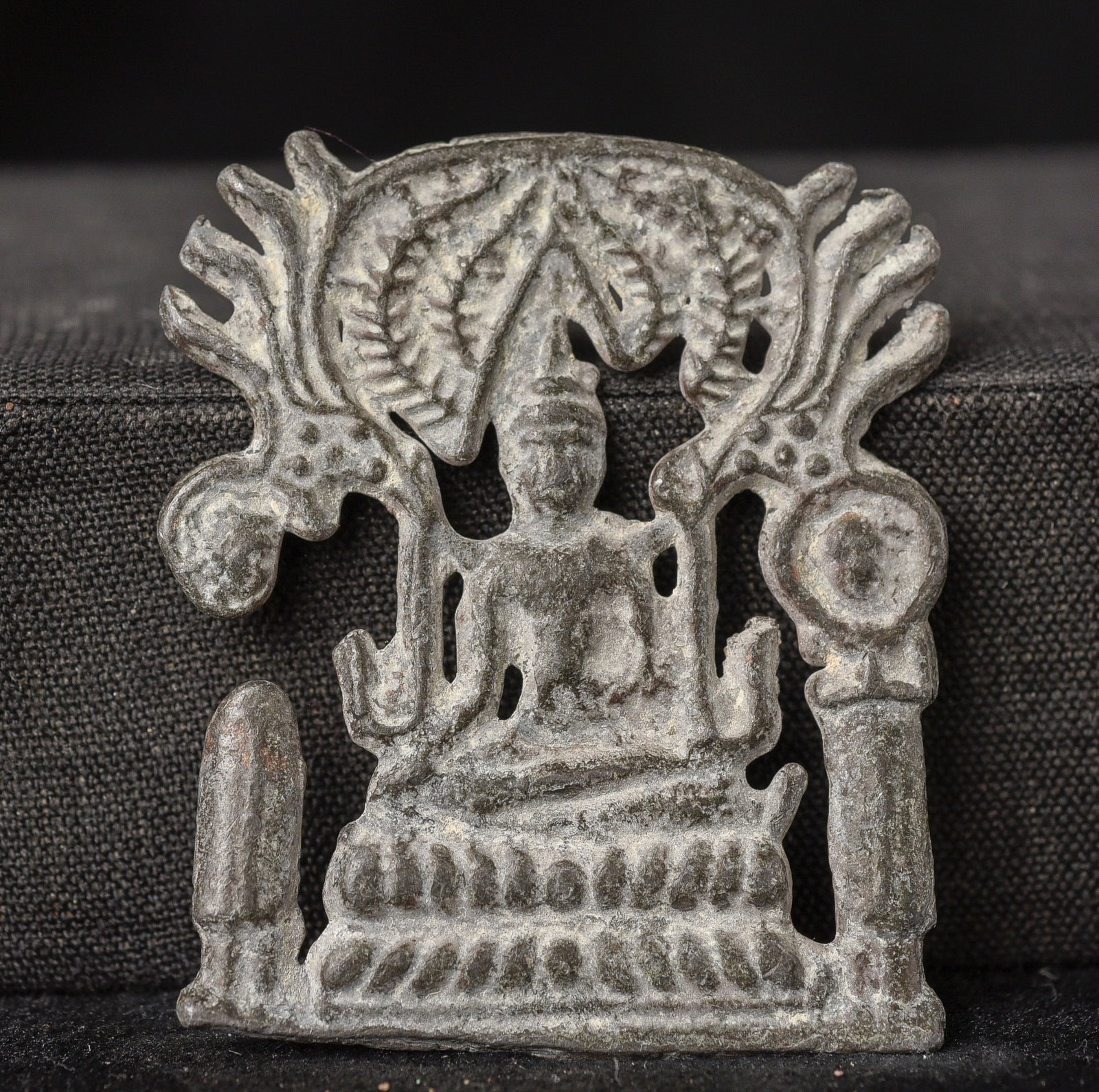 18/19thC Thai lead alloy Buddha Cut-Out Plaque.: 18/19thC Thai lead alloy Buddha Cut-Out Plaque. He is sitting under a stylized Bodhi Tree. I believe this type is from the Ratinakosin Period ( 1.875"H x 1.5"W x .0625"D )