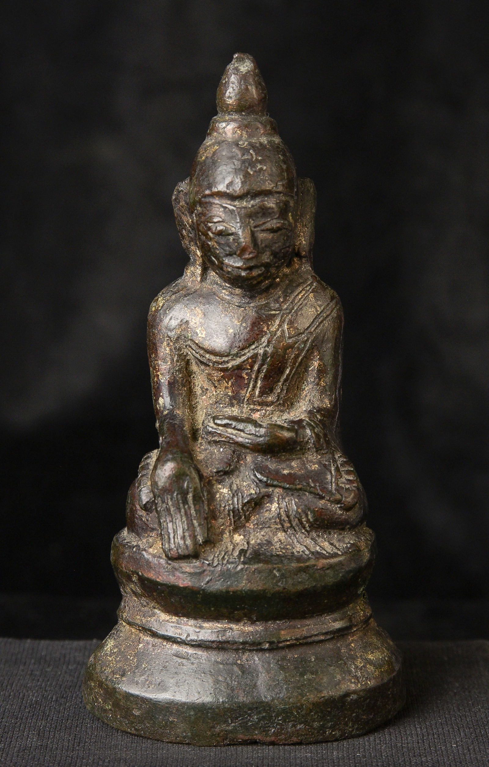 18th century Burmese bronze Buddha in a late Ava/early Shan style: 18th century Burmese bronze Buddha in a late Ava/early Shan style ( 5.5"H x 3.75"W x 1.75"D ) - 315g . In worn condition, the face still shines through. Priced to sell.