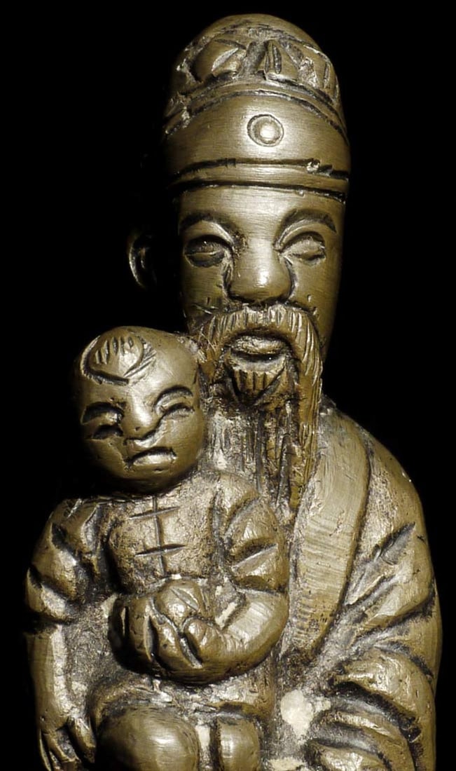 Unusual antique Chinese bronze holding a baby. Measures: Unusual antique Chinese bronze holding a baby. Measures 4" tall.