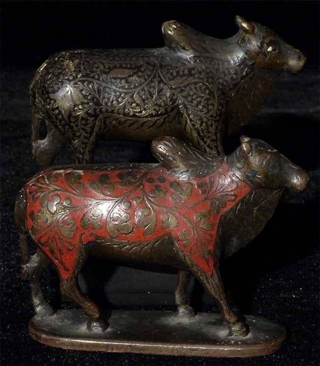 Pair of Antique Inlaid Bronze Nandi Figures: Pair of antique inlaid bronze Nandi figures - one with red, one inlay with black. Both stand just shy of 2 inches.