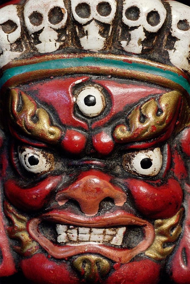 Powerful old polychrome terracotta Mahakala from Mongolia.: Powerful old polychrome terracotta Mahakala from Mongolia. Probably hung on the wall facing the door to protect the home. Sits 3 3/8 inches tall by 2.25 inches wide.