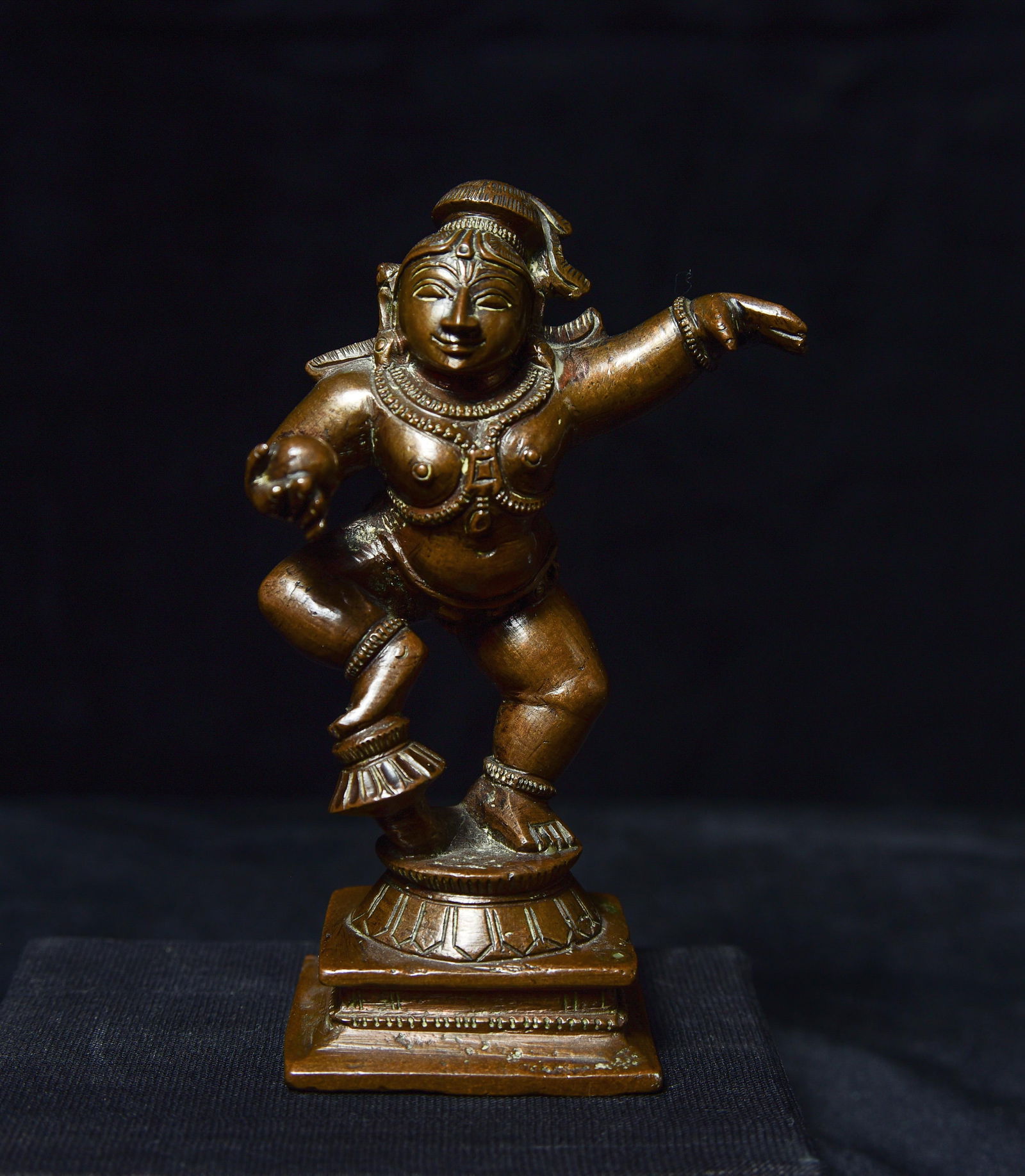 Antique bronze. 4.25" tall, base measures approximately: Antique bronze. 4.25" tall, base measures approximately 1.75" square. Very joyous!