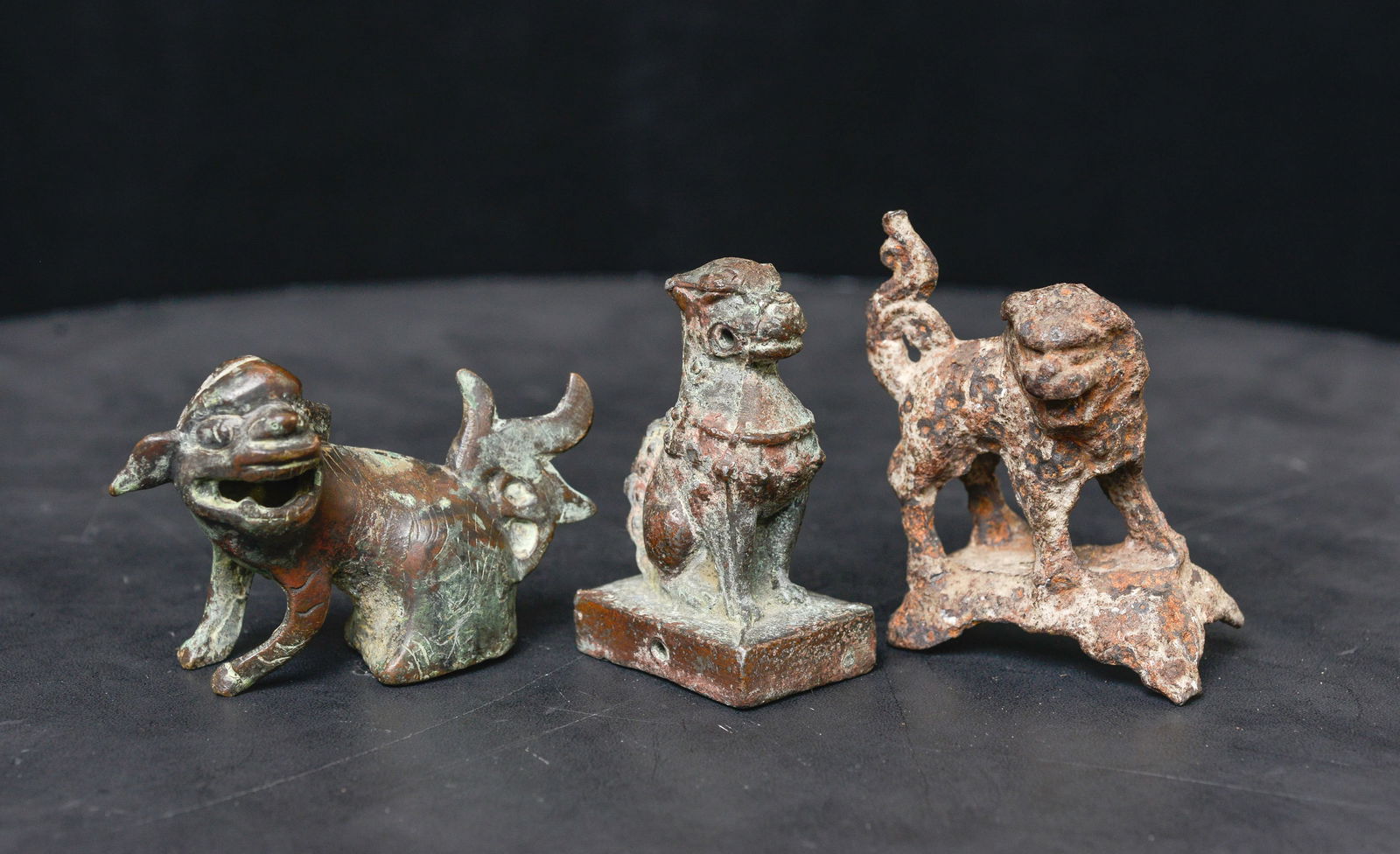 Box Lot #8 - This lot is a group of 3 Foo Dogs, 19thC or earlier.: Box Lot #8 - This lot is a group of 3 Foo Dogs, 19thC or earlier. Two look to be iron and one bronze.