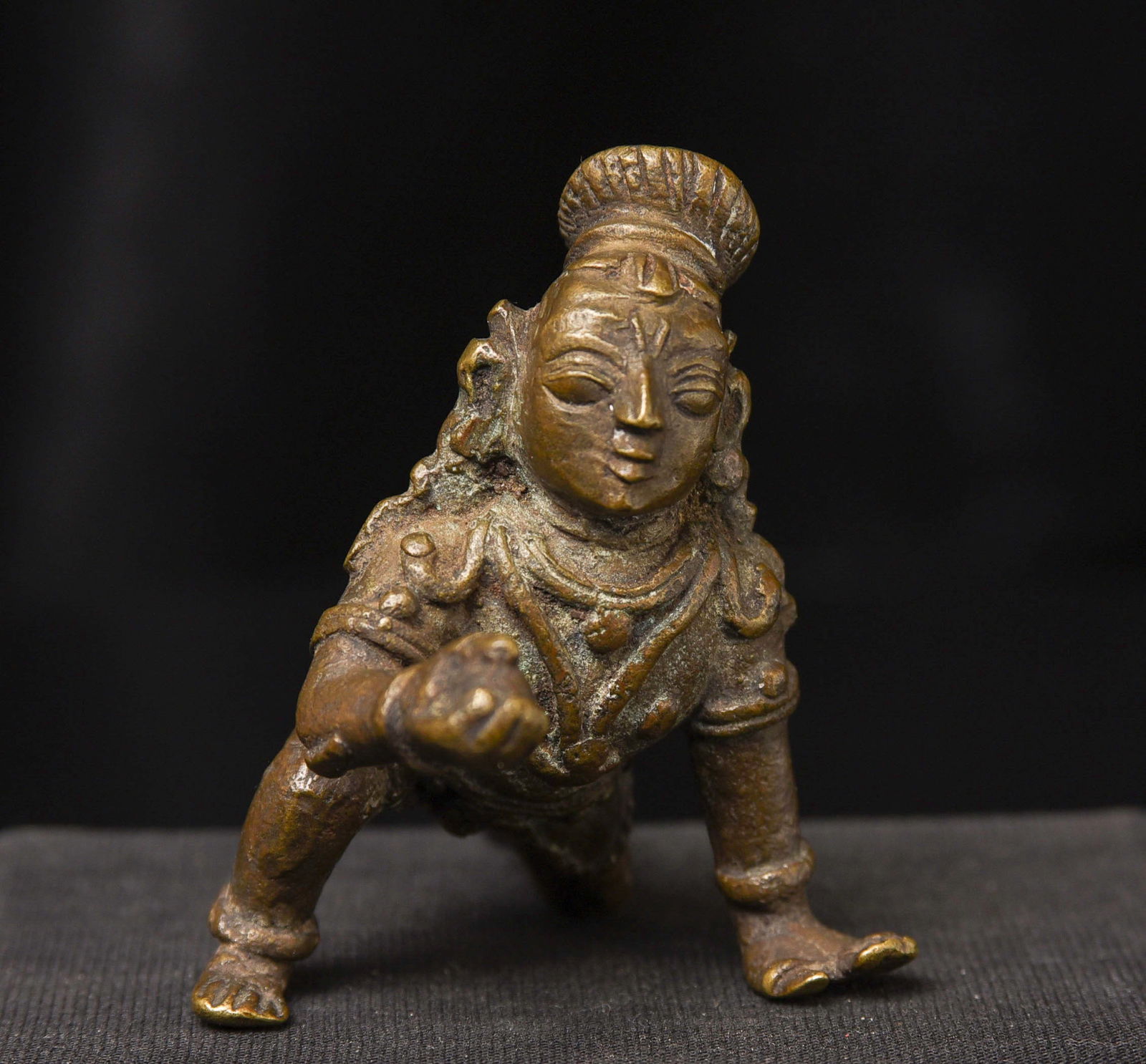 Nice antique bronze baby Krishna with his butterball.: Nice antique bronze baby Krishna with his butterball. Classic example of his typeThis piece measures 3 1/4 inches long x 2 inches wide x 3 inches tall Deep discount.