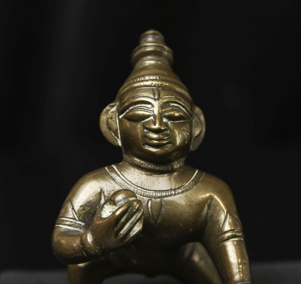 Antique Indian bronze Baby Krishna with his butterball.: Antique Indian bronze Baby Krishna with his butterball. Happy face. (3"H x 2.25"W x 2.75"D ) - 245g