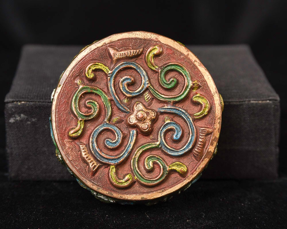 Two Mongolian ritual items.: Two Mongolian ritual items. The larger one has the eight auspicious symbols and is used for meditation practices. The smaller one has beautiful, flowing, colorful designs. I purchased both from a Mong