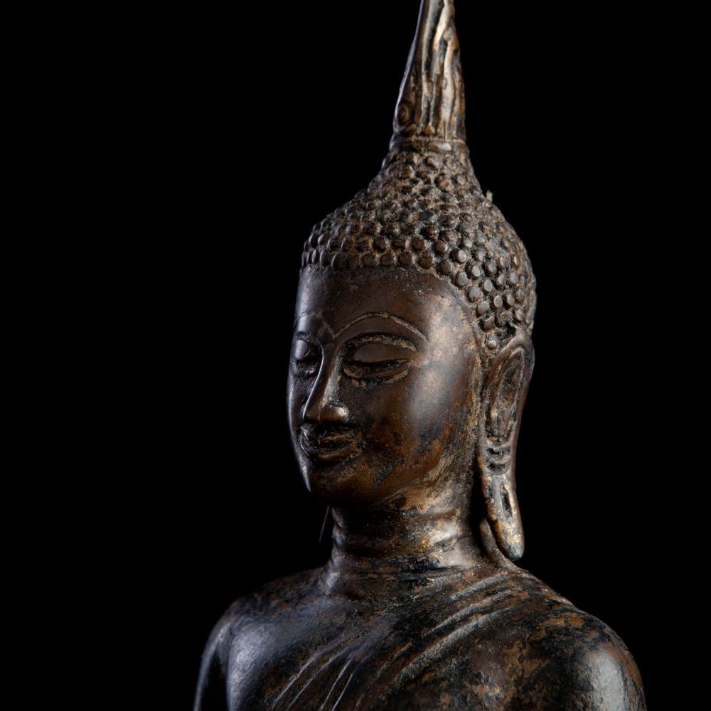 Authentic 15thC Thai Bronze Sukhothai Buddha.: Authentic 15thC Thai Bronze Sukhothai Buddha. Sits 8.75 inches tall for the bronze only, 10 inches including the base. Nice cheerful example. The loer part of the oricinal base is missing. It was not