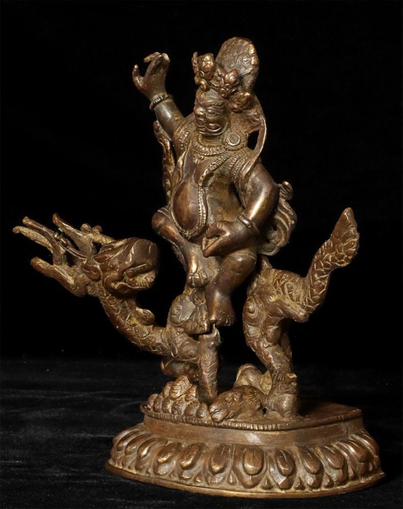 Antique Solid-cast Mongolian deity on dragon. - 2