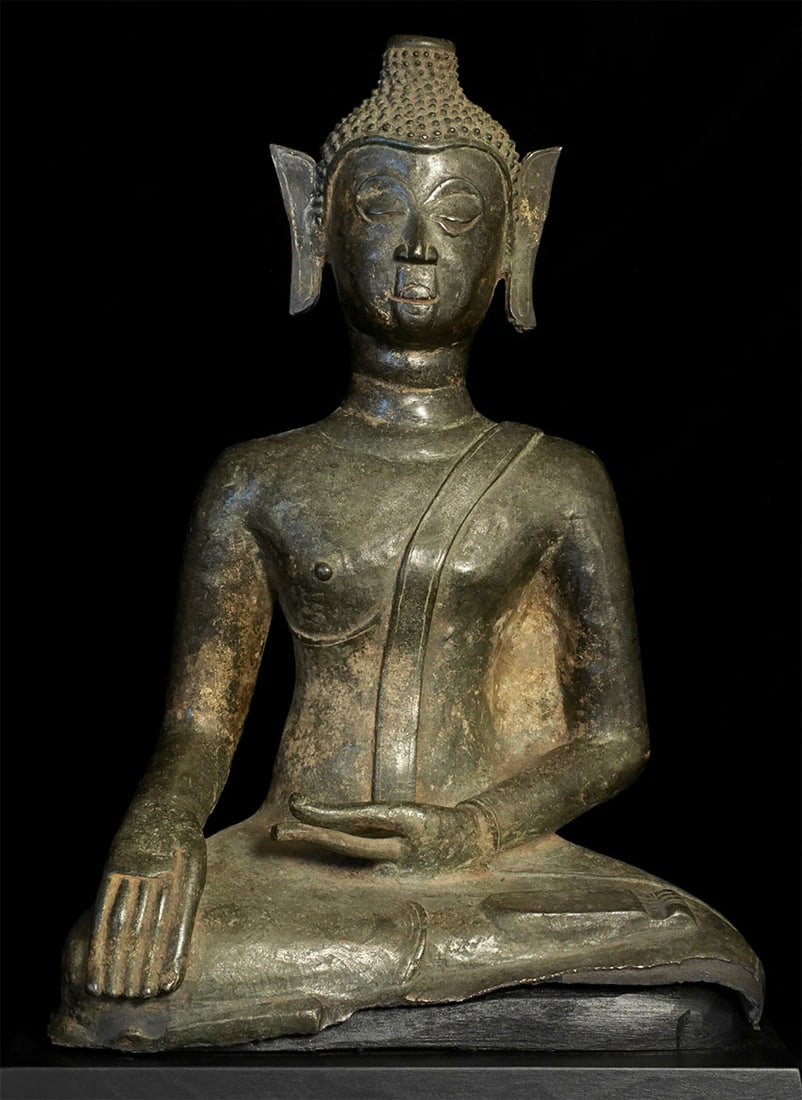 15thC Large, Unique Joyful Laos Bronze Buddha- Folk-Style: Fifteenth-century Lao Buddha in a delightful Lanna(Northern Thailand)/Laos folk style. Loss of original base and finial, plus one ear mostly replaced. Larger than his 15-inch height (17 inches on