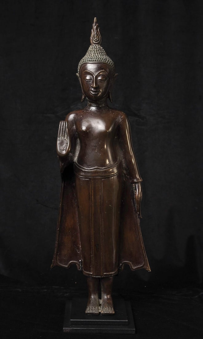 17thC Northern Thai Standing Bronze Buddha, Nice Quality! Hard to Find: Well cast 17/19thC Northern Thai Standing Bronze Buddha. Stands fine with its back against a wall or other surface. A nice example of its type. Has a custom base. (20.75"H x 7.5"W X 3.875"D ) - 10lbs