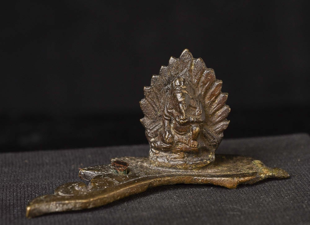 Early Ganesh- part of a fragmentary bronze (gilded on: Early Ganesh- part of a fragmentary bronze (gilded on bottom) which was part of a larger assembly. 1.25 inches tall, 2.75 inches long. Nepal? Ganesh is complete and stands firmly as a statue on his