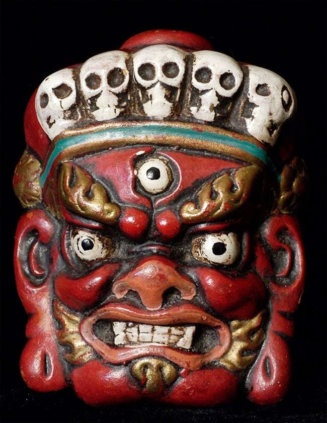 Powerful old polychrome terracotta Mahakala from Mongolia.: Powerful old polychrome terracotta Mahakala from Mongolia. Probably hung on the wall facing the door to protect the home. Sits 3 3/8 inches tall by 2.25 inches wide.