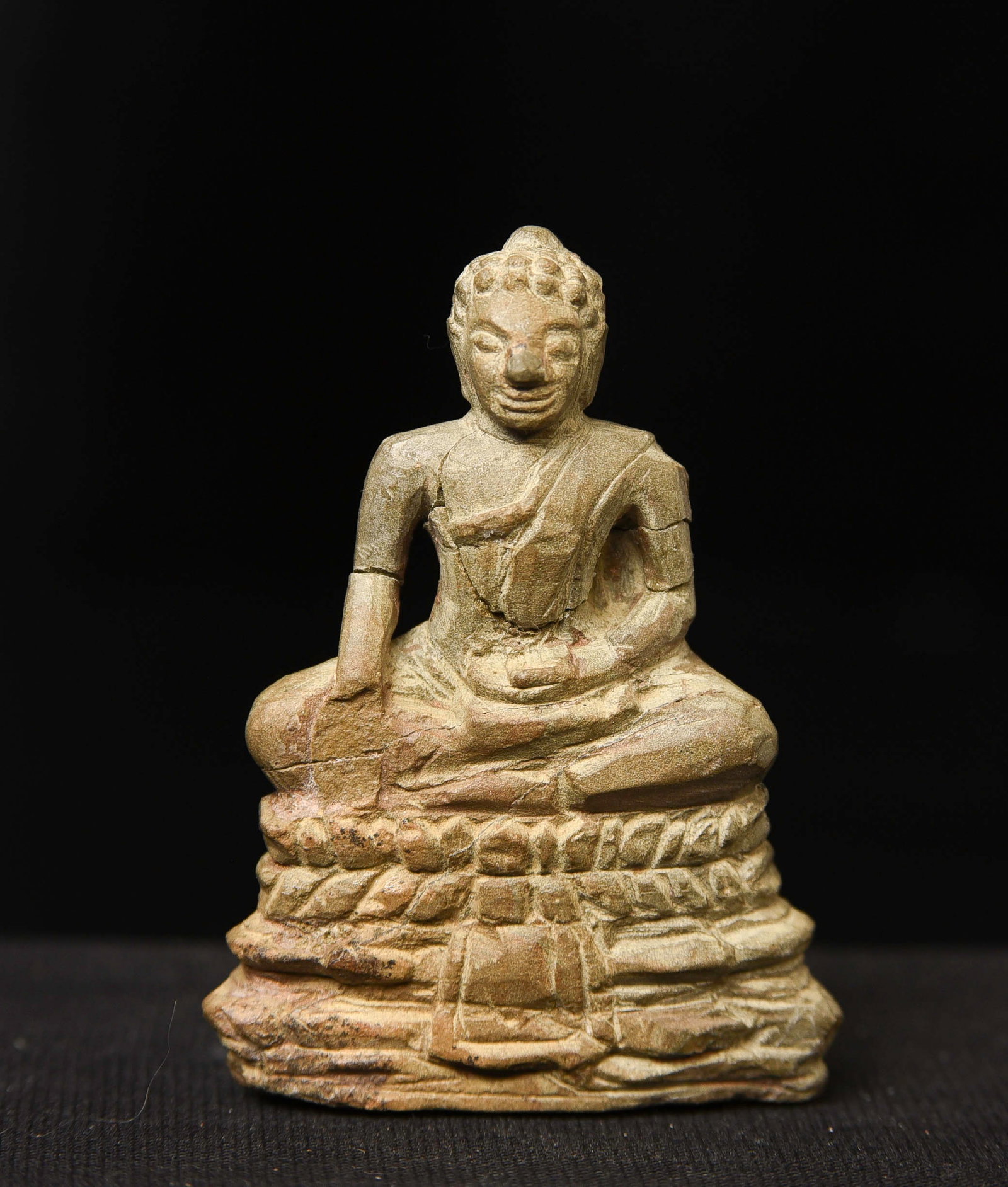 Very sweet small 17/18thC Cambodian stone Buddha. One hand is missing and the nose is repaired.: Very sweet small 17/18thC Cambodian stone Buddha. One hand is missing and the nose is repaired. Excavated by the previous owner's ancestors in 1912 in Cambodia, Great folk art. (2.25"H x 1.75"W) for