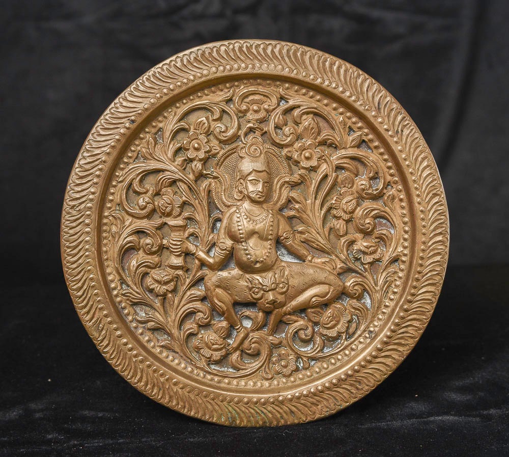Antique Indian figure sculpted into a pierced copper plate.: An interesting Indian figure sculpted into a copper plate. Has age to it. (6.125"diameter ) - 240g