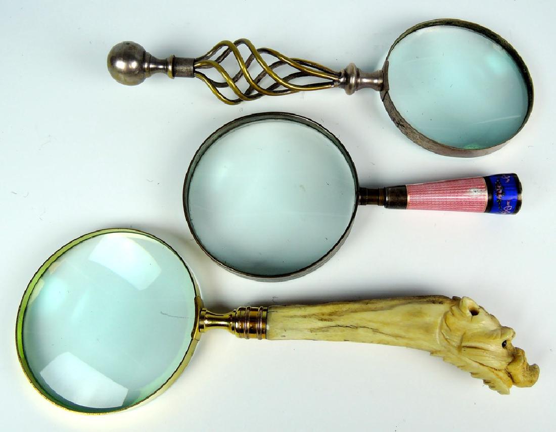 3 Magnifying Glasses: One has carved bone boar's head, one enamel over silver, one with twis strands, good condition, some chips on enamel, longest 11"