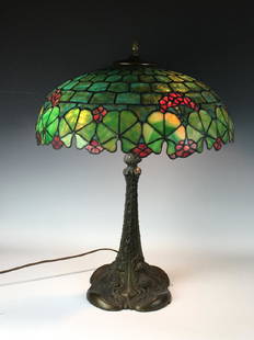 Duffner & Kimberly Leaded Table Lamp: Circa 1920, shade made up of green pillow shape squares and flowers along the sides, decorated with red flowers, stained glass, mounted on a Duffner & Kimberly base, base is pictured in Paul Crist’s