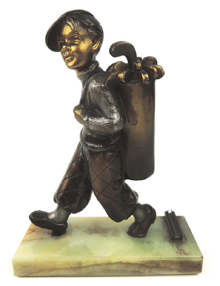 Golfer Cigar Lighter after Lorenzl: Circa 1920, Austria, a cold painted figural cigar lighter modeled after Lorenzl as a golfer carrying his bag of golf clubs, central club is the wand, of spelter, mounted on square green onyx plinth mo