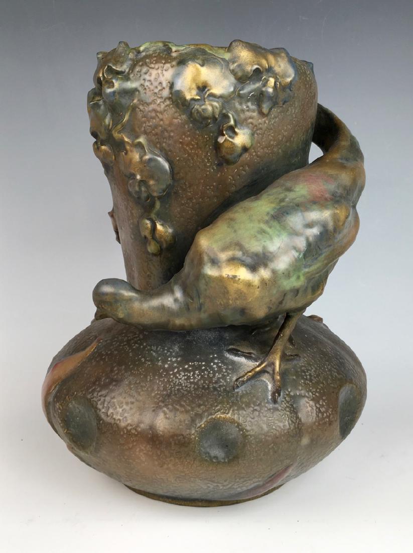 Amphora Art Nouveau Quail Vase: Circa 1890, having a figure of a quail perched on the bulbous rim with his tail wrapped around the top of the vase, marked with Amphora marks, good condition, 10" x 8"