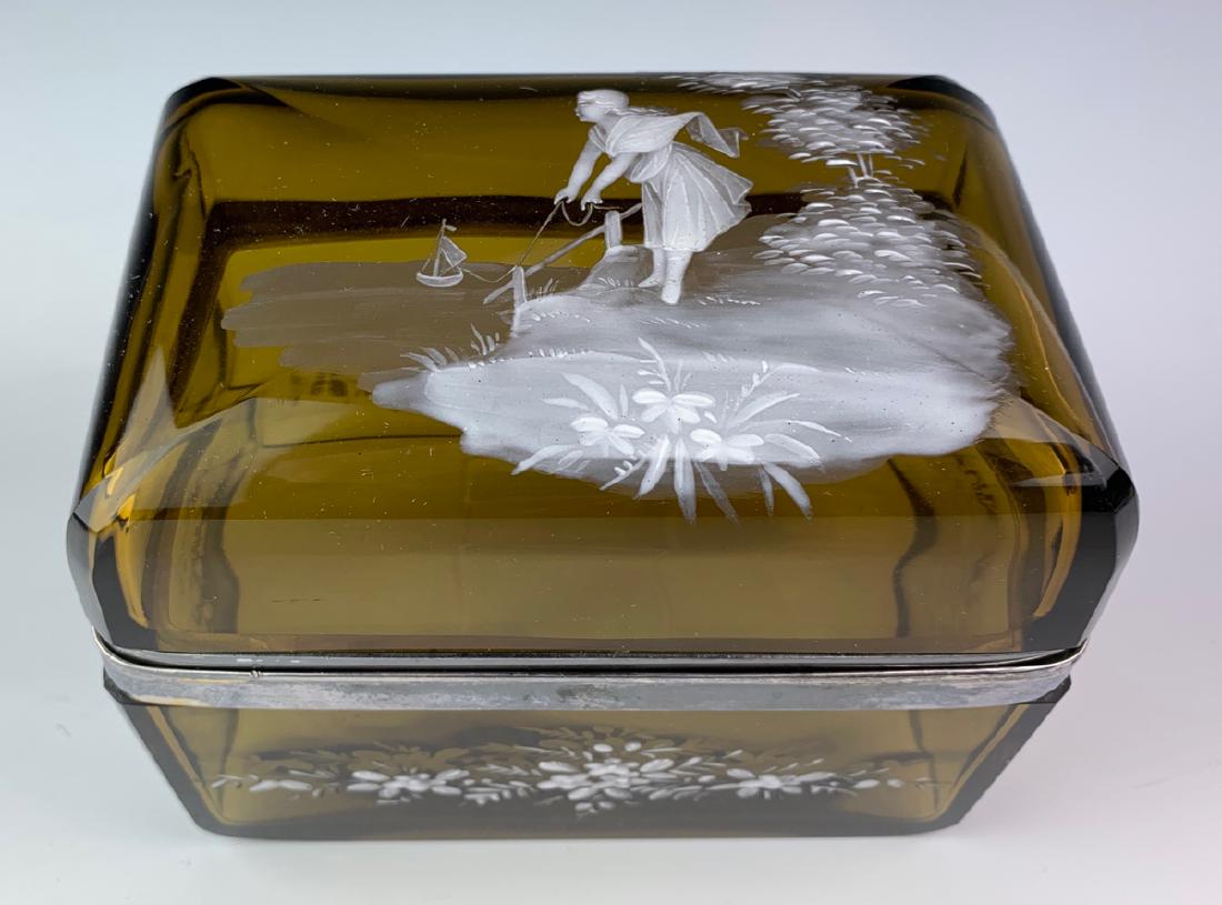 Vintage Mary Gregory Glass Box C. 1920: Having a smoke amber glass body decorated with Mary Gregory scene of a girl playing with her boat toy, very good condition, 6.25" x 4" x 5.5"