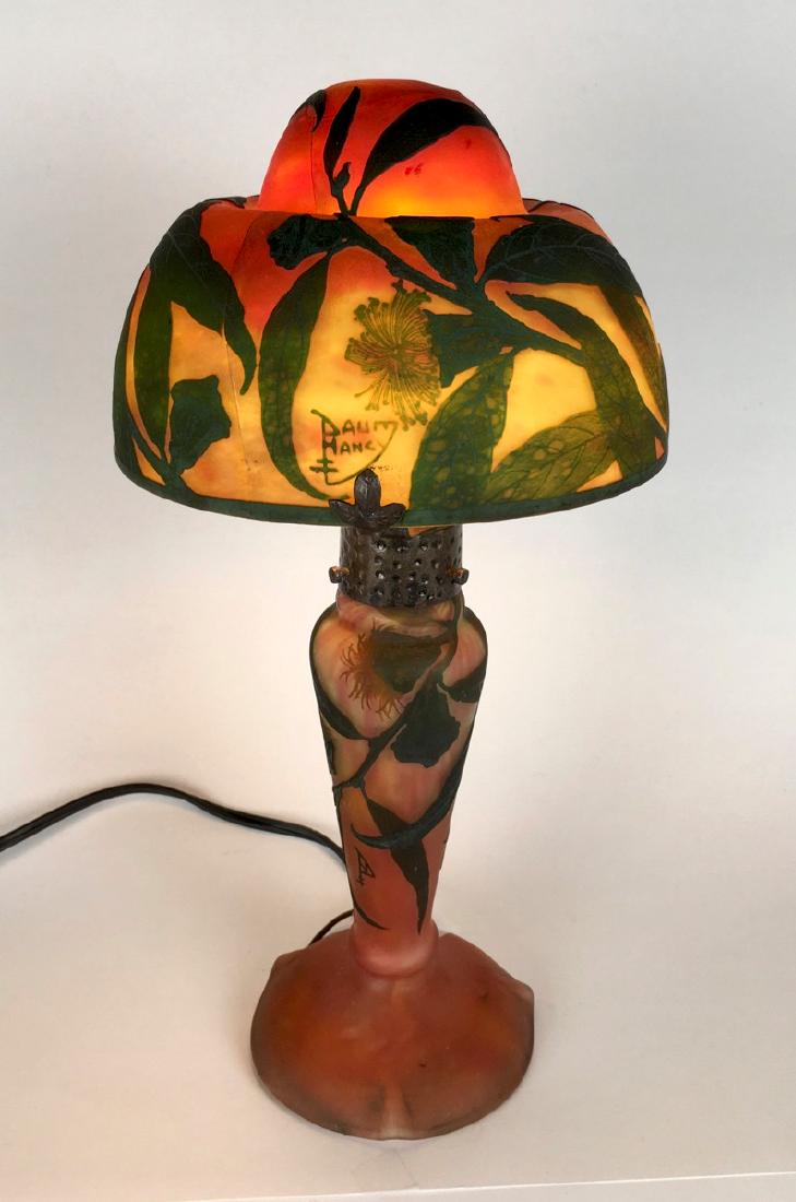 Original Daum Nancy Cameo Glass Lamp: Offering an original Daum Nancy cameo glass lamp with leaves and flowers over an orange mottled glass body, unfortunately the shade is cracked, both shade and base are signed, shade support by 3 metal