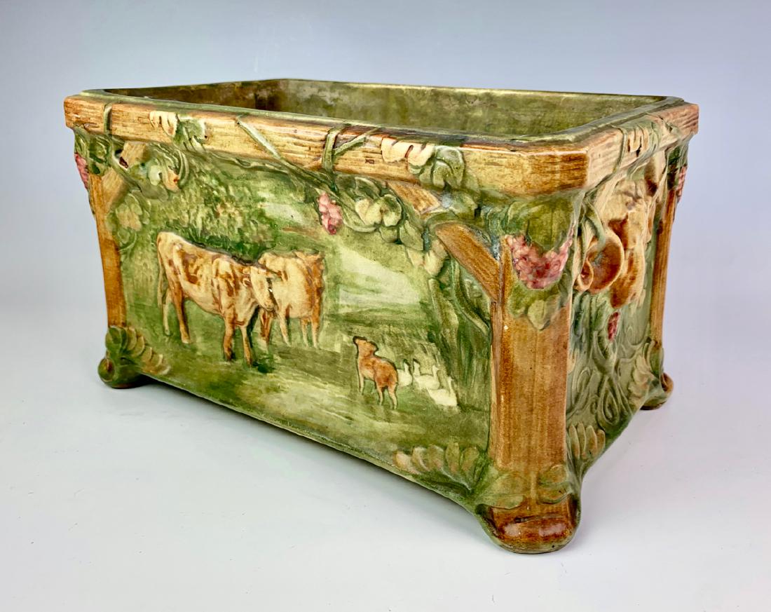 Rare Weller Flemish Window Box Planter w/ Cows: Circa 1920, rare and uncommon Weller Flemish planter with scenes of cows and ducks embossed on the longer panels with ram heads on the ends, impressed "Weller" in large block letters on bottom, good c