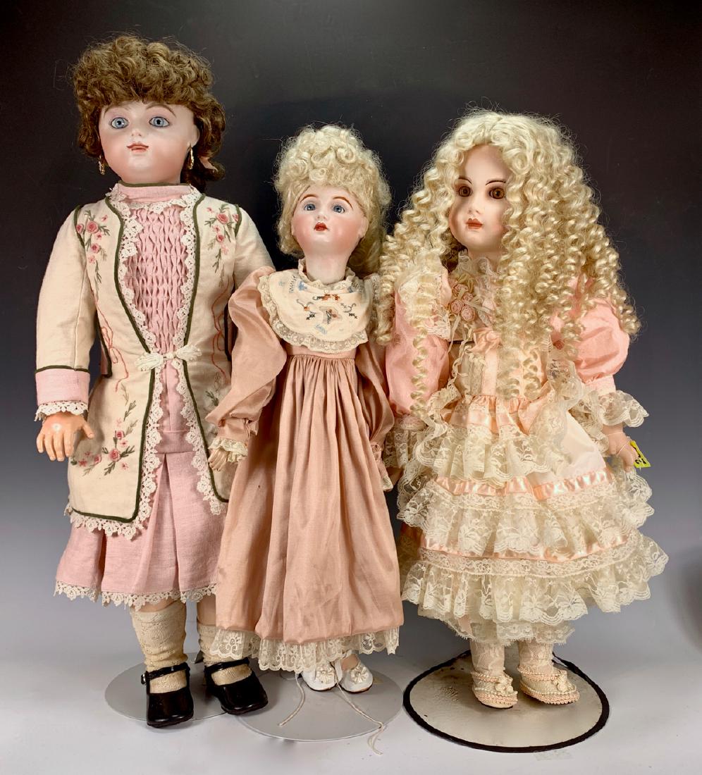 Group of 3 Repro Bisque Head Dolls: One reproduction F.G. Scroll bebe, blue paperweight eyes, bisque head, on reproduction Gesland-type body, 29"; one reproduction Tete Jumeau, blue glass eyes, fully-jointed composition body, 24.5"; one