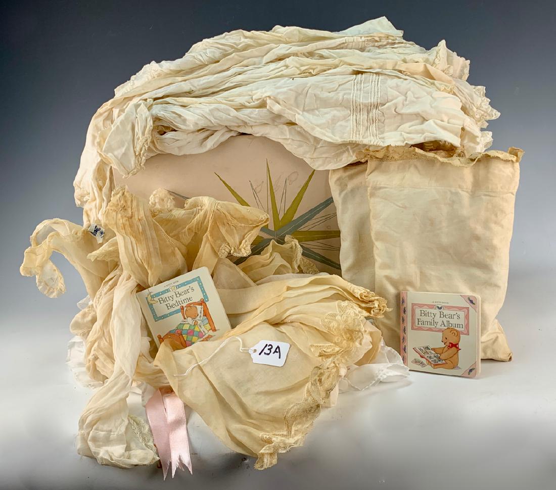 13 Antique & Vintage Baby Doll Garments: For medium to large baby dolls, including christening gowns, long slips, two baby doll pillows, two small vintage baby books; items in old May Co. gift box worn and dingy from age, good condition