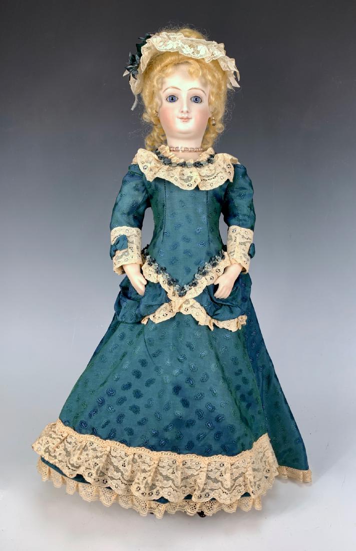 Artisan Bru Smiler Fashion by Lavigne Binner: Circa 1996, blue paperweight eyes, cloth body with bisque lower arms and legs, molded black button-up boots, clothing made with old fabric, very good condition, 18"