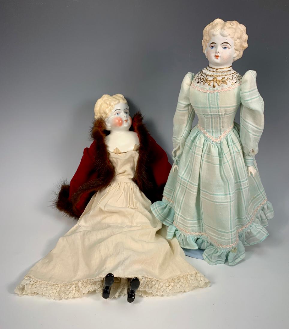 2 German Blond Haired Dolls: One c. 1880 repaired shoulder plate, turned head, antique cloth body with repro china arms and lower legs, clothing made with old fabric, poor condition, 19"; one c. 1890, German Parian blond with mol