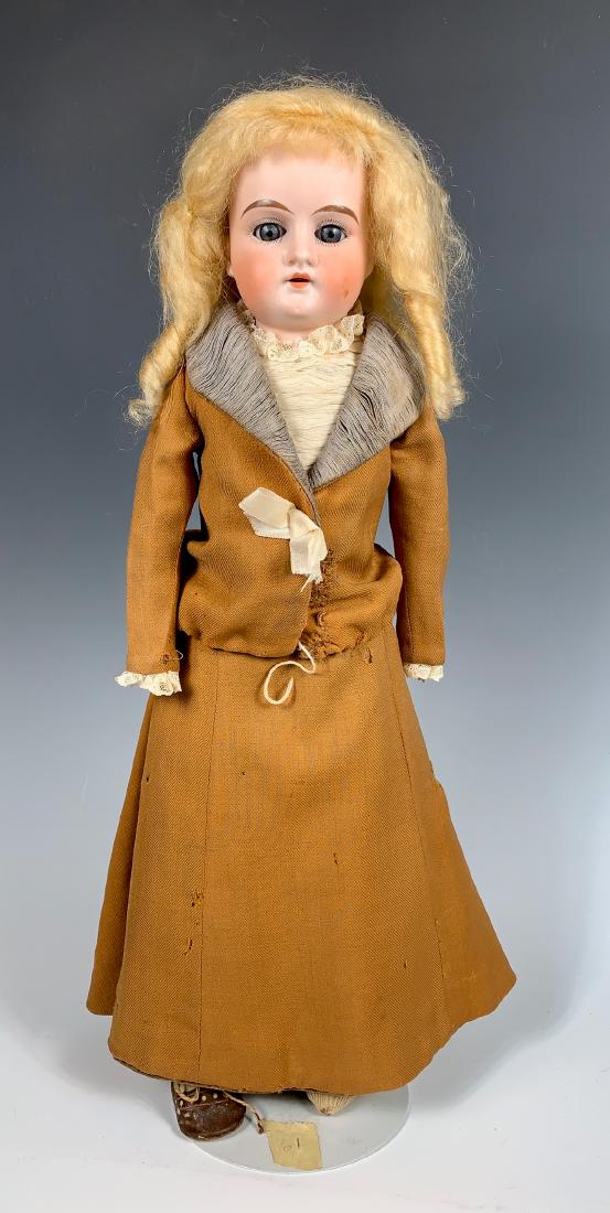 German Bisque Head Doll "Lilly" C. 1895: Blue sleep eyes, shoulder head with stiff neck, open mouth with teeth, "Lilly" incised on back of head, new mohair wig, bisque hands, left index finger broken, one missing shoe, original clothes, 17"