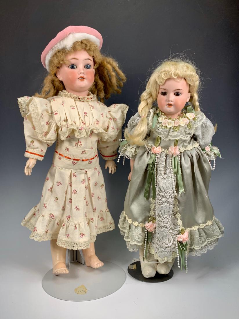 2 German Bisque Head Dolls: One Kley and Hahn Walkure c. 1900, blue sleep eyes, fully-jointed German body, left pinky finger repaired and unpainted, hairline on left side of neck, dark blond mohair wig, repro Jumeau factory dres
