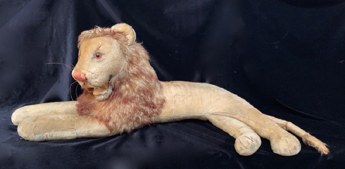 Oversized Steiff Lion Store Display: Oversized stuffed lion made by Steiff with button in ear, 12" L shaped tear on center of body, small tear above right eye, 36" x 28"