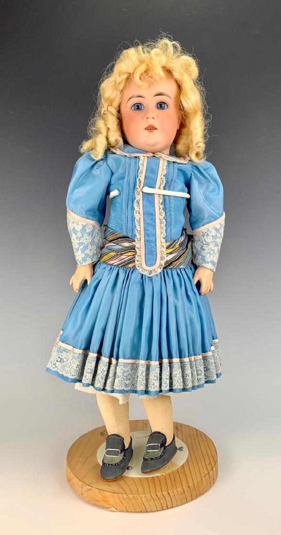 Fine Quality Bisque Doll C. 1890: German probably Kestner, blue set eyes, fine fully-jointed German composition body, original plaster pate, girdle with straps holding stockings, synthetic blond wig, all clothing made with new fabric,