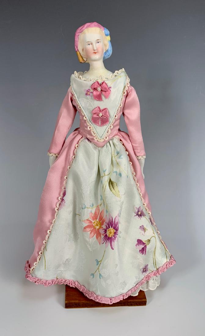German Parian "Empress Eugenie" C. 1865: Painted blue eyes, molded feather hat and snood, neck repair, antique cloth body with china arms, all clothing made of old fabric, fair condition, 11"