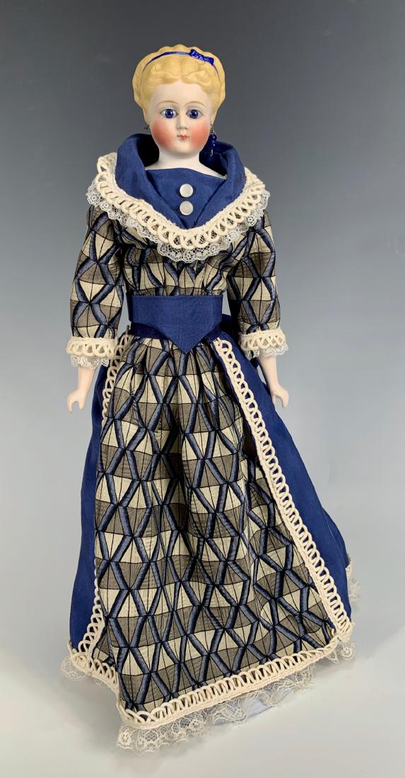 German Parian C. 1870: Blue glass eyes, pierced ears (one earring missing), fancy blond hairdo with blue ribbon, leather gusseted body with cloth arms, composition lower arms, totally repaired shoulder plate, all clothing m
