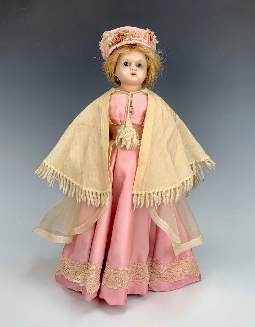 German Reinforced Poured Wax Doll C. 1865: Blue glass eyes, cloth body, leather arms, human hair wig pulled back, clothing made with antique fabric, undergarments antique, good condition, 17"