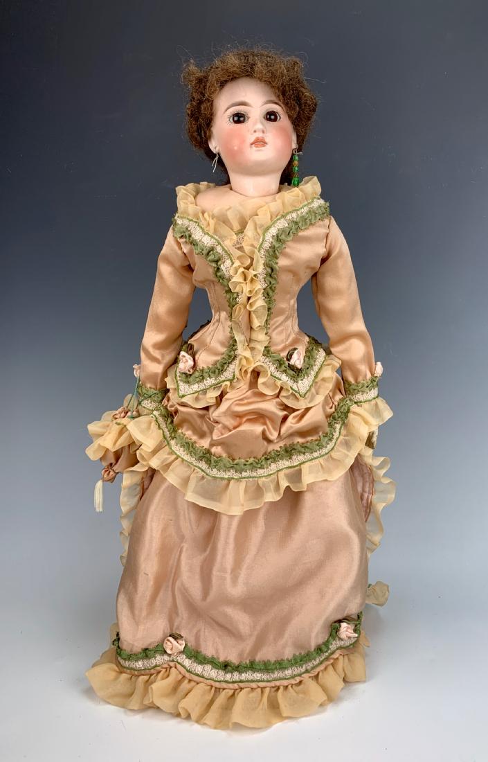 German Belton Lady for French Market C. 1880: Brown paperweight eyes, pierced ears, closed dome, Jumeau face, marked "183", newer shoulder plate and antique head are not a match, leather gusseted body, antique leather buttoned boots, clothing mad