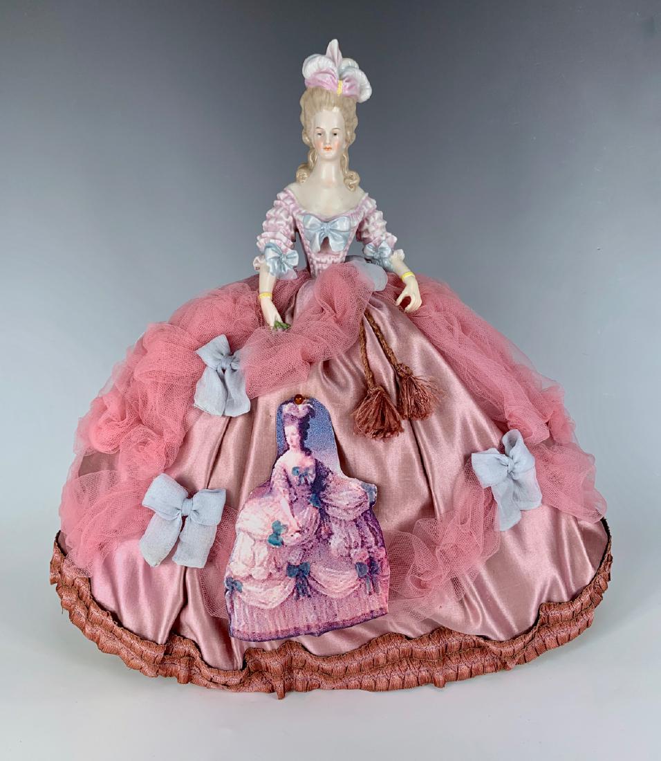 Pin Cushion Doll "Marie Antoinette" C. 1920's: German fine china doll depicting Marie Antoinette, both arms away, elaborate molded bodice, elaborate satin gown of old fabrics, very good condition, 13"