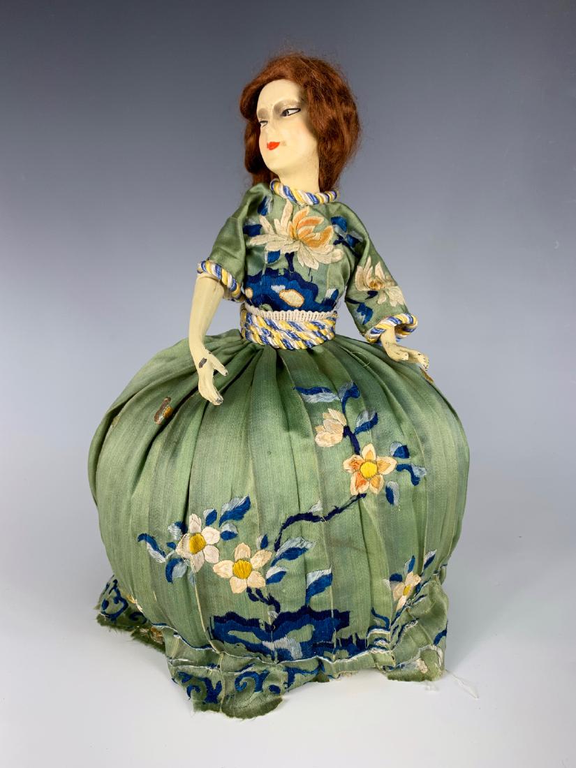 12" German Pin Cushion Doll C. 1920's: Composition head, metal arms, embroidered silk dress over stuffed base, very good condition, 12"