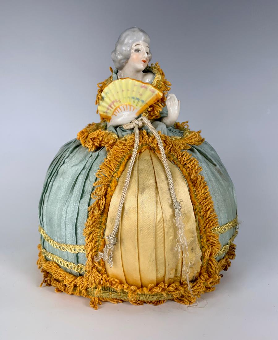German Porcelain China Pin Cushion Doll C. 1920's: One arm away, Marie Antoinette type, molded fan, elaborate original costume over stuffed base (stain on bottom), very good condition, 7.5"