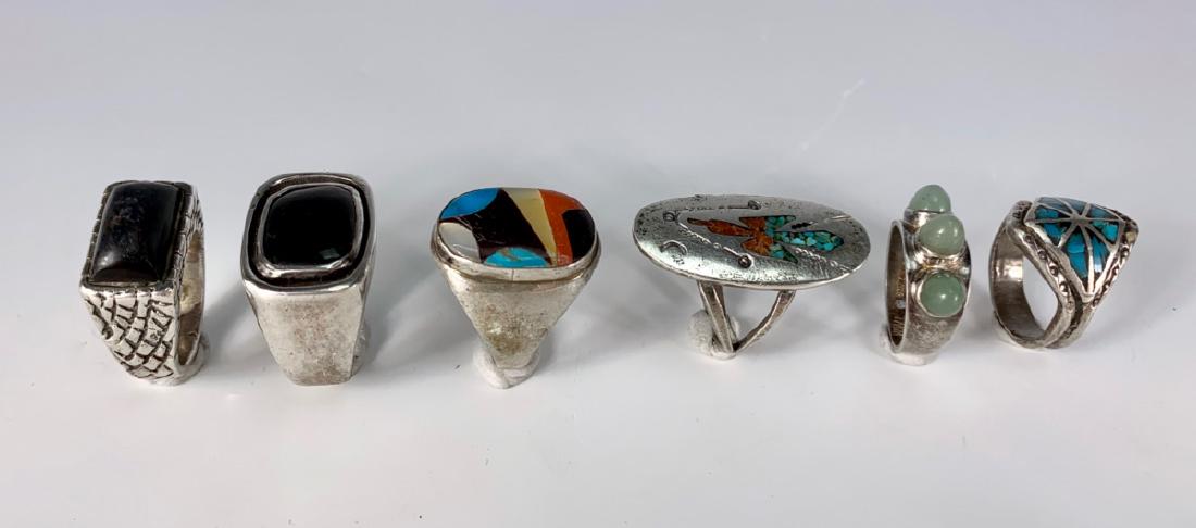 6 Native American Mixed Stones Rings: Consisting of 1 turquoise, 2 turquoise and coral, 2 ebony, 1 green stones, sizes 6 - 10, good condition
