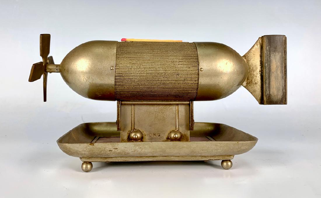 Rare Airship Cigar Cutter, Match Dispenser C.1900: Made in Germany, rare tobacciana has a cigar cutter (operated by the blade), a match dispenser that lifts up to grab a match and replaces when pushed down, also the tail has the striker, marked "D.R.G