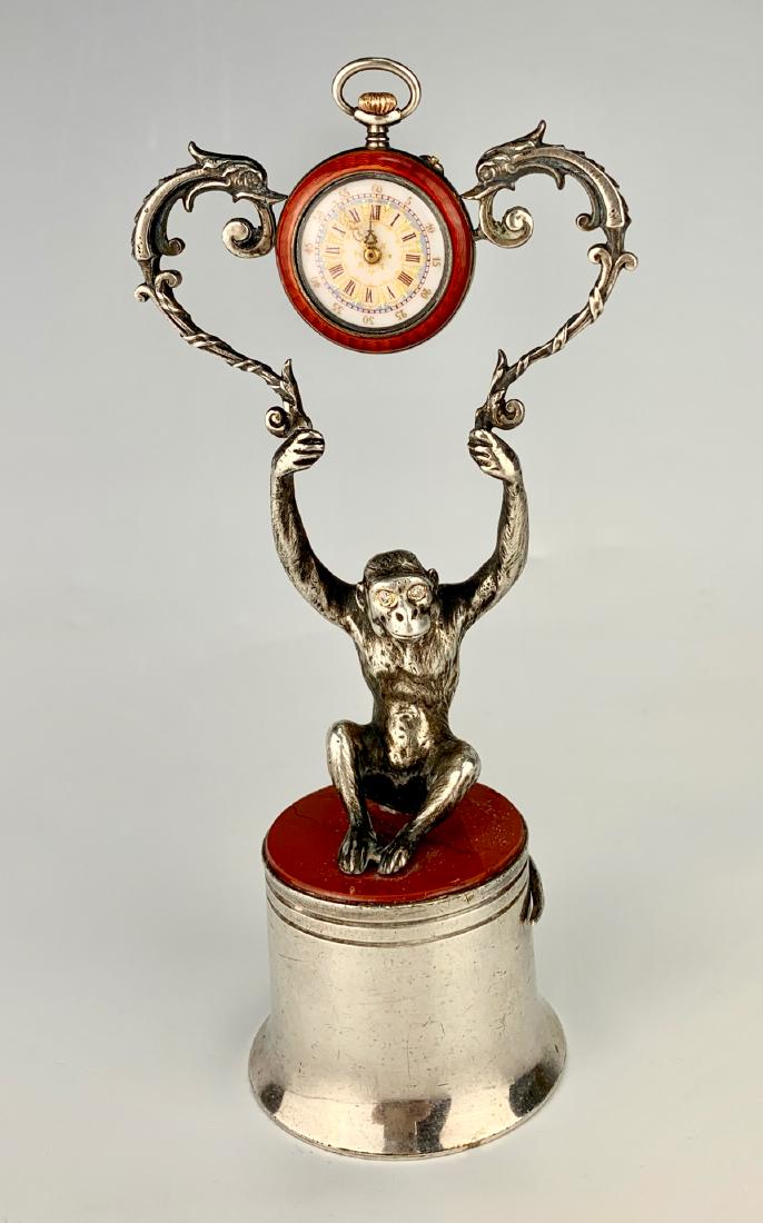 Cartier Sterling Silver Monkey Watch: Depicts a sterling silver monkey holding up a watch with red enamel, he sits on red marble and sterling silver base, monkey has diamond eyes, marked "Cartier" "843262" and "925", very good condition,