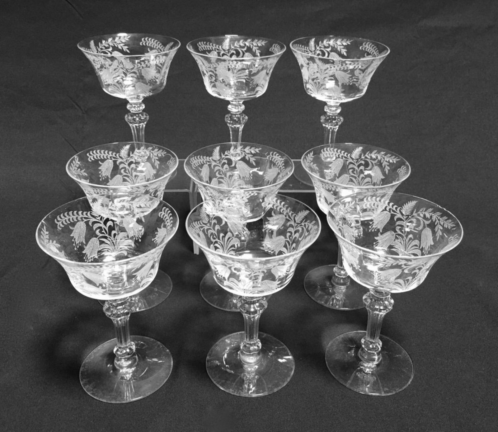Set of 9 Etched Wine Glasses: Circa 1920's, having an etched bellflower design, attributed to Fostoria, 4 stems have flea bites on lip, 1 has minor chip on edge, 5.5" height