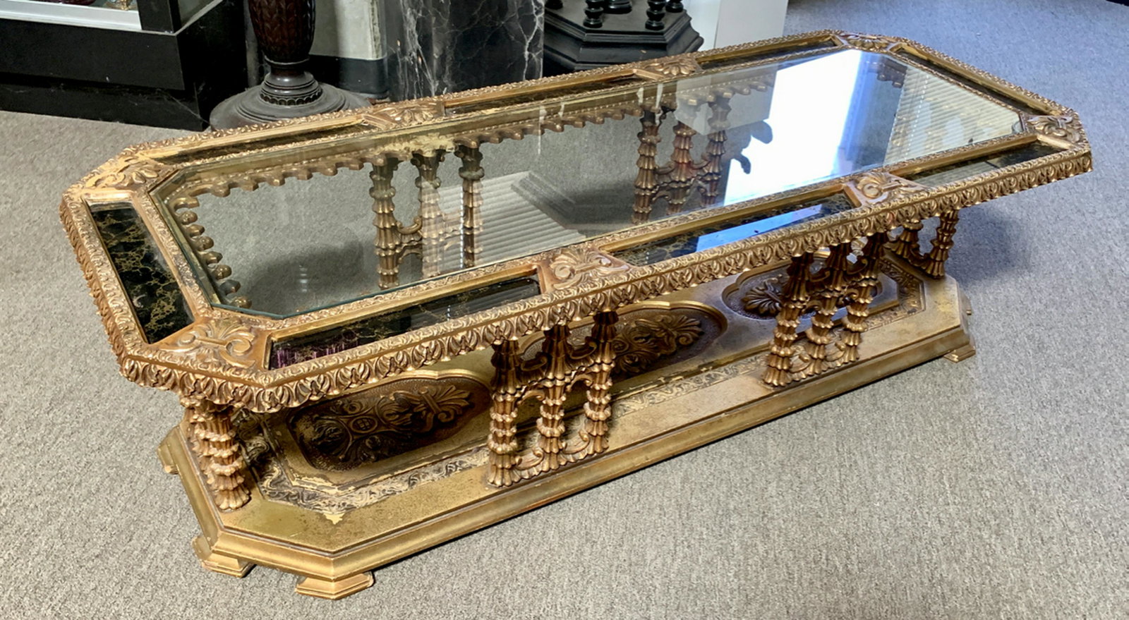 Mid Century Ornate Gilt & Mirrors Coffee Table: Circa 1960's, very ornate carved gilt coffee table inlaid with gold veined black mirror, very good condition, 60" x 24"