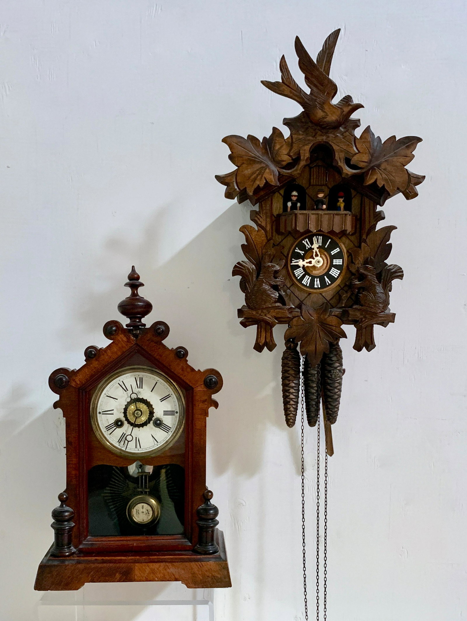 2 Clocks, One Cuckoo and One Victorian Mantle: Lot includes 2 clocks, one being a newer cuckoo wall clock and the other a Victorian mantle clock made by Junghans, good condition, clocks are not guaranteed