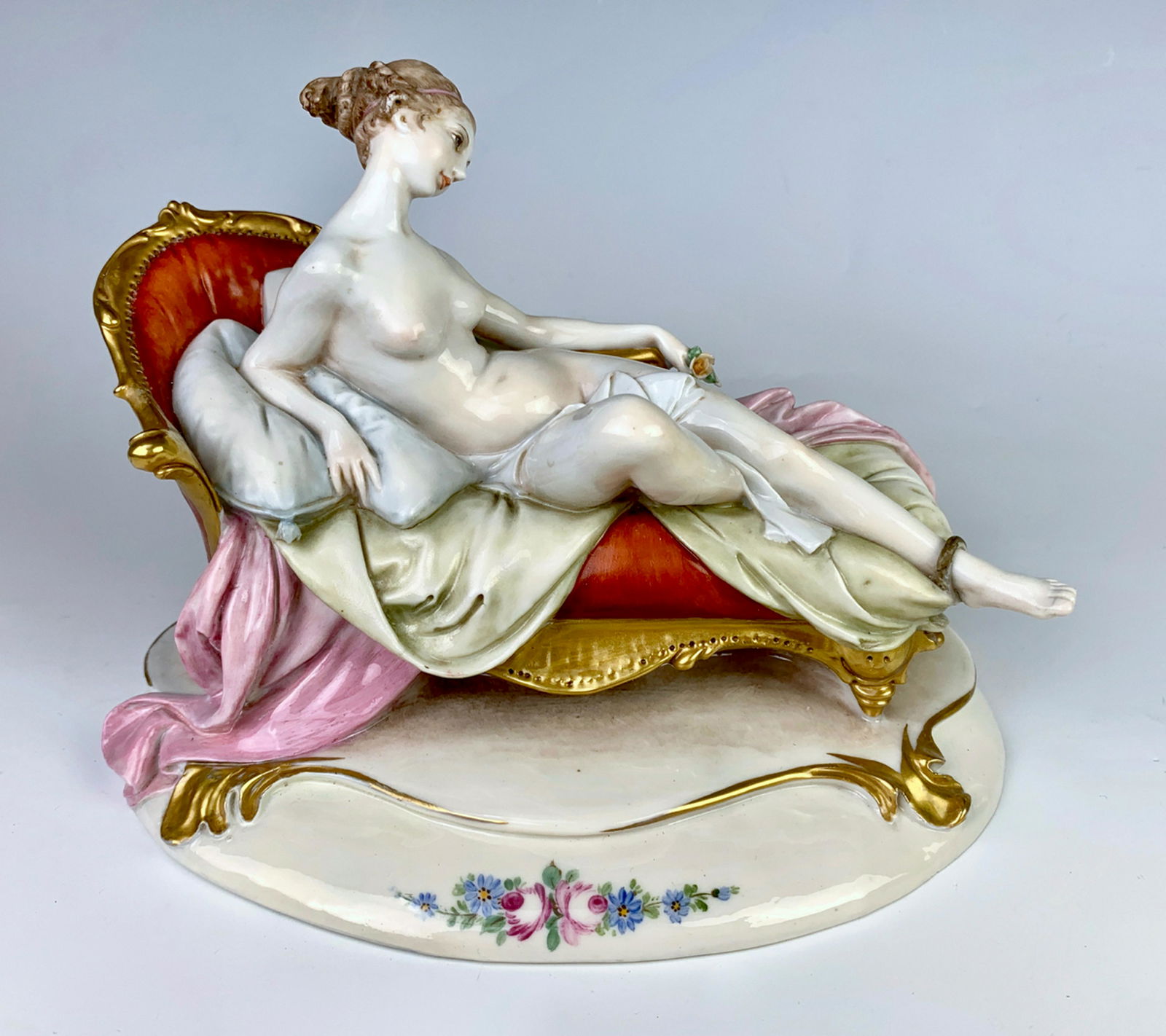 Capodimonte Figural Reclining Nude on Chaise: Circa 1950, porcelain figurine of pretty woman on chaise lounge, marked on bottom with Capodimonte mark, gilt highlights, good condition, some repair to ankle, 7.5" length