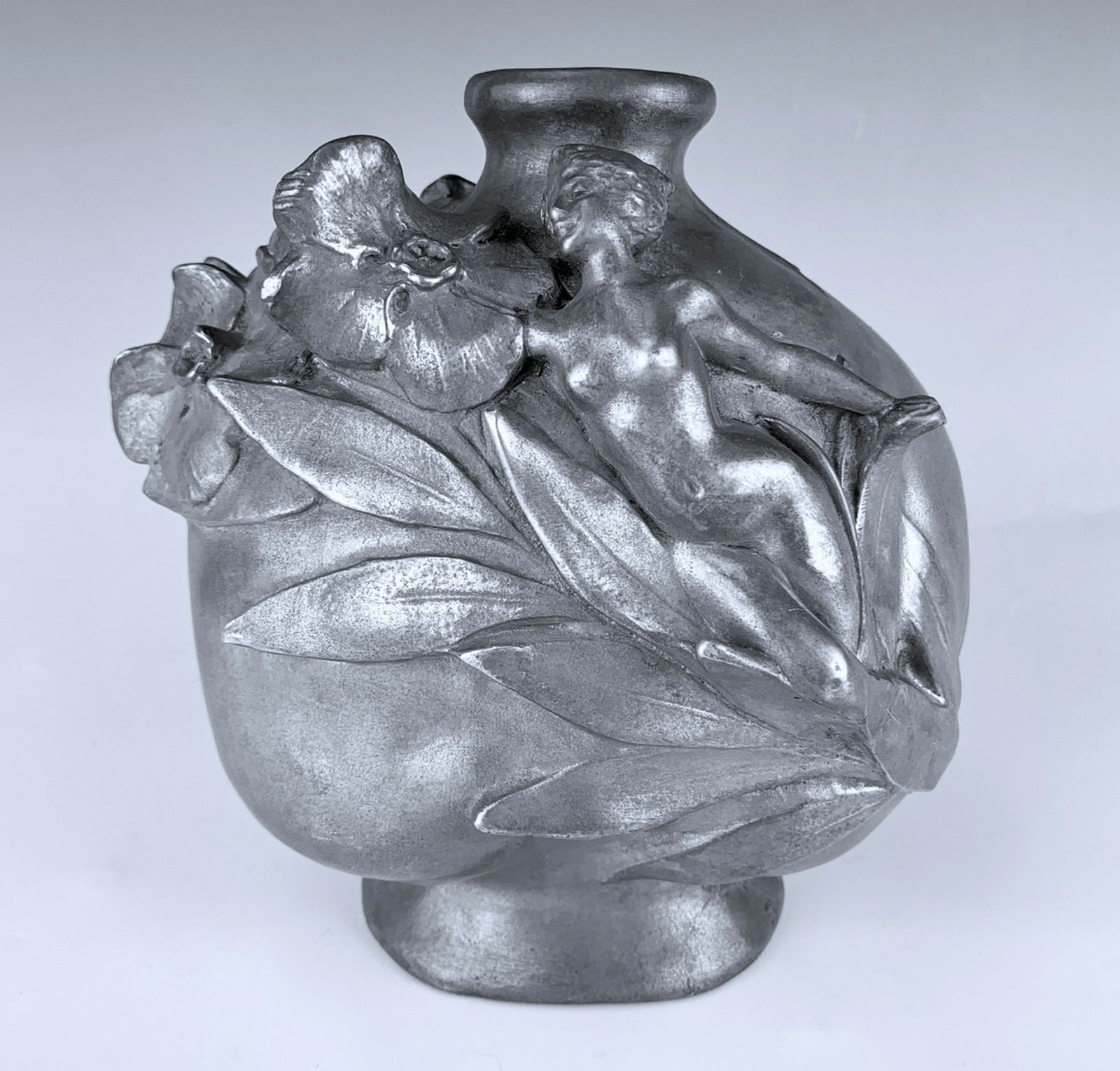 Jules Jouant (1836-1921) Art Nouveau Vase: Circa 1900, depicting a nude nymph amongst some pansy flowers on a sphere body, signed "Jouant", made of pewter, good condition, 6.75" height